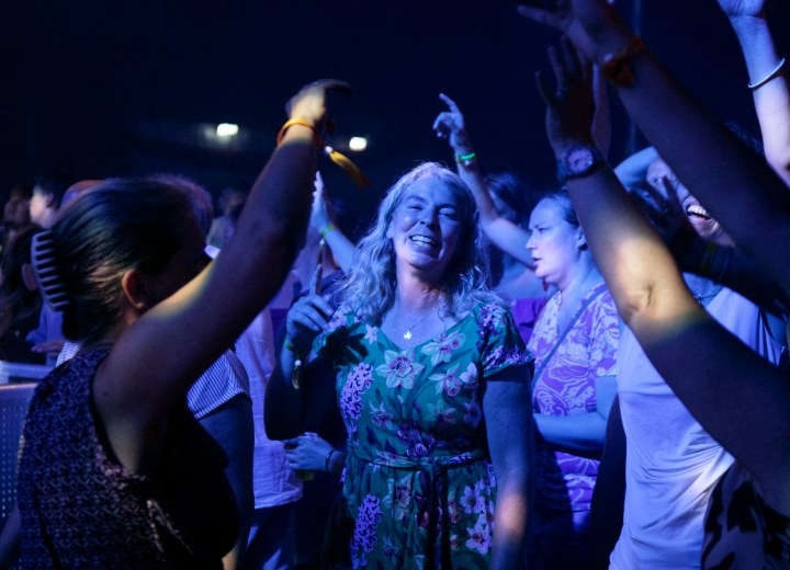 An evening crowd at an outdoor music festival
